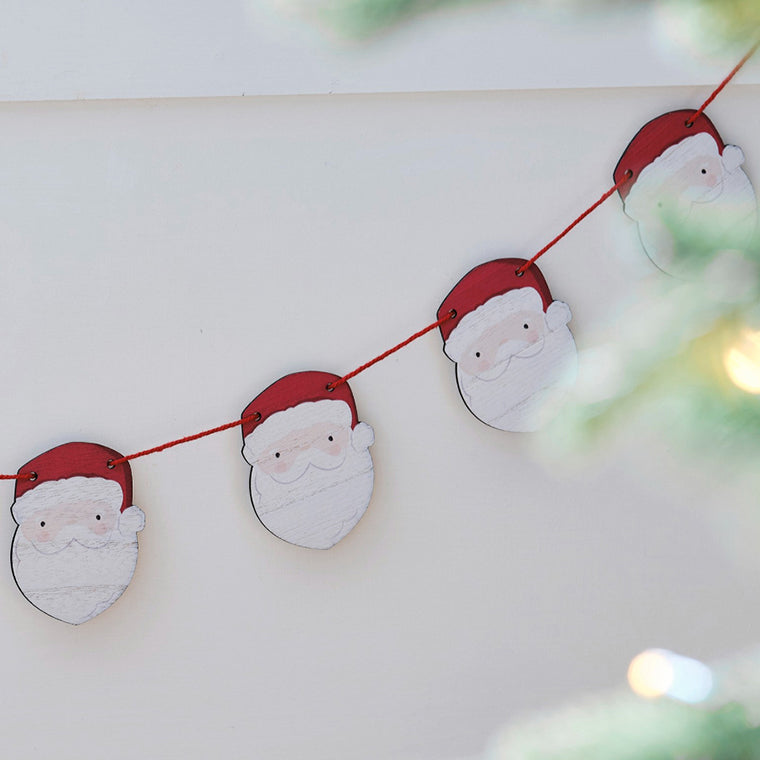 Decorative string with Santa Claus faces on a light background