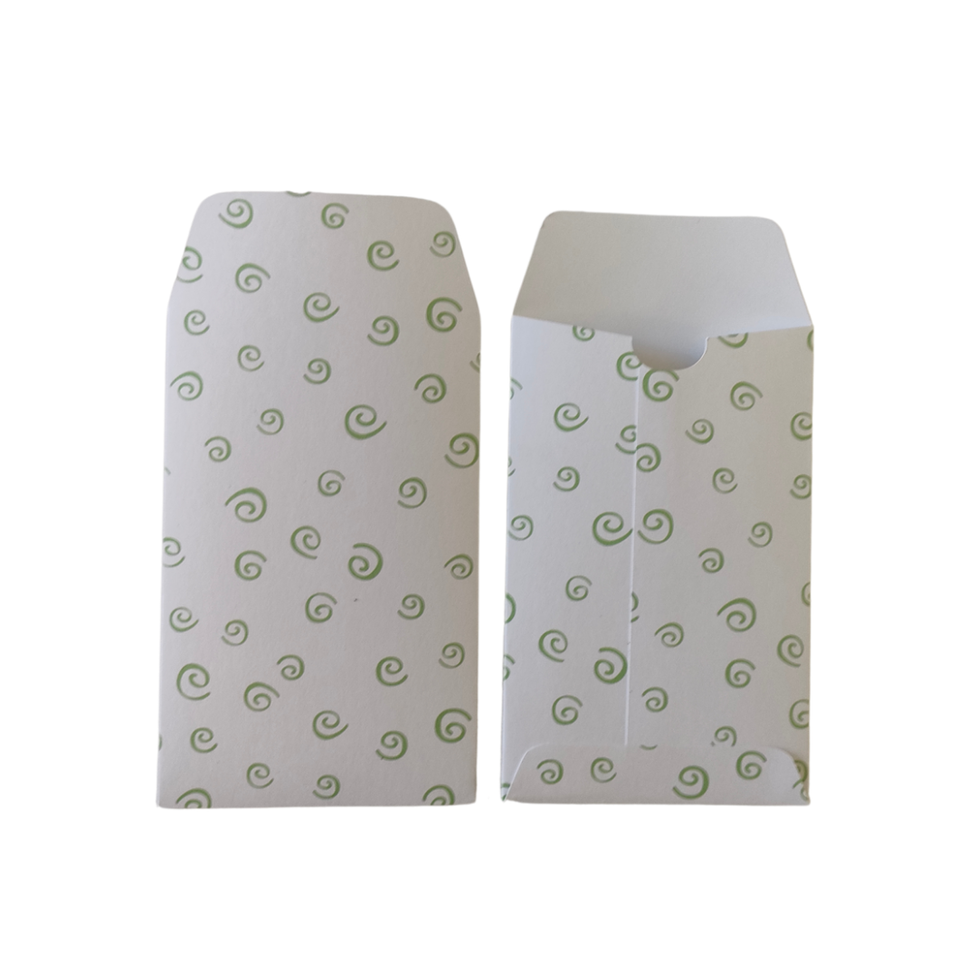 Two white envelopes with green spiral patterns