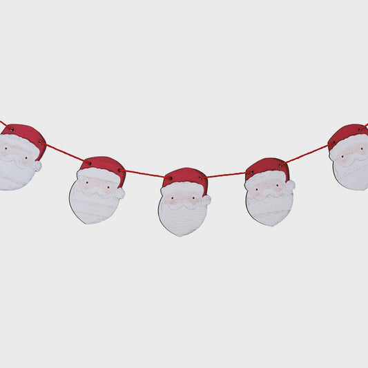 String of Santa Claus faces with red hats on a white background