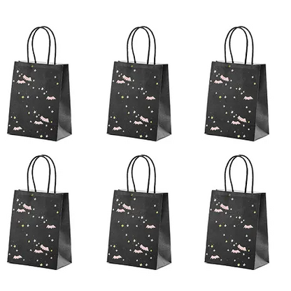 Set of six black gift bags with star and moon designs on a white background