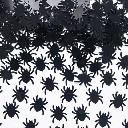Black spider-shaped confetti on a white background