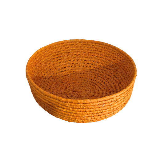 Round woven basket on a white background