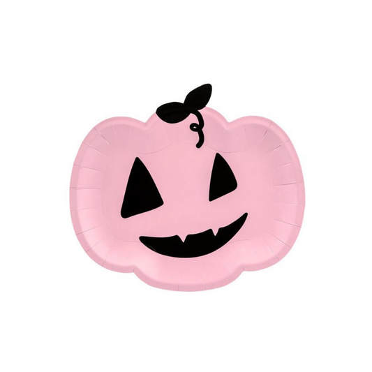 Pink pumpkin-shaped plate with black face details on a white background