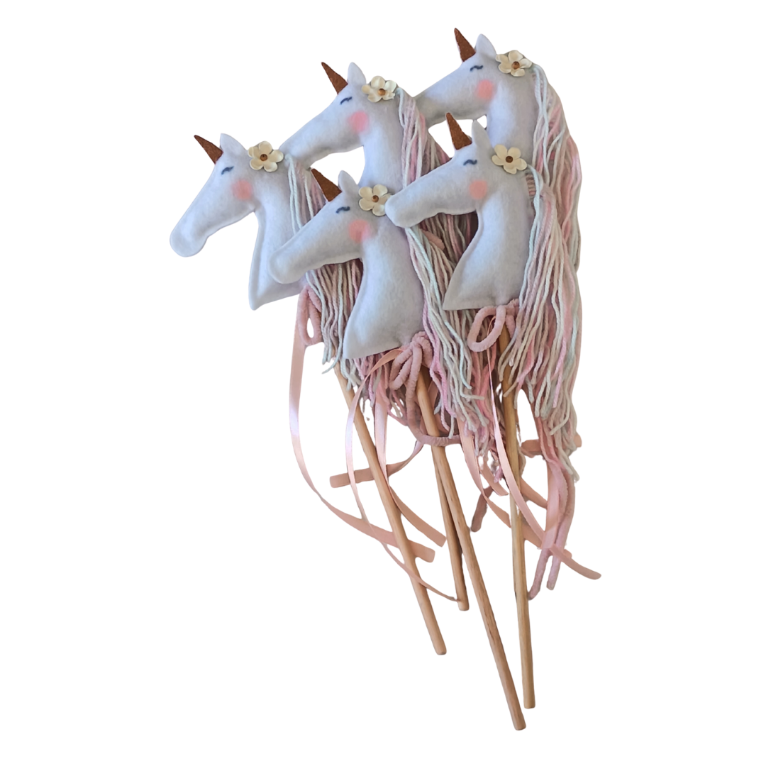 Unicorn-shaped wands with pink on a white background