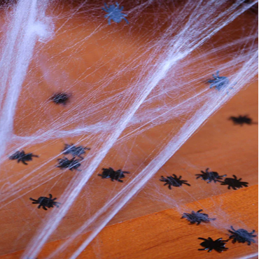 Spider webs with small black spiders on an orange background