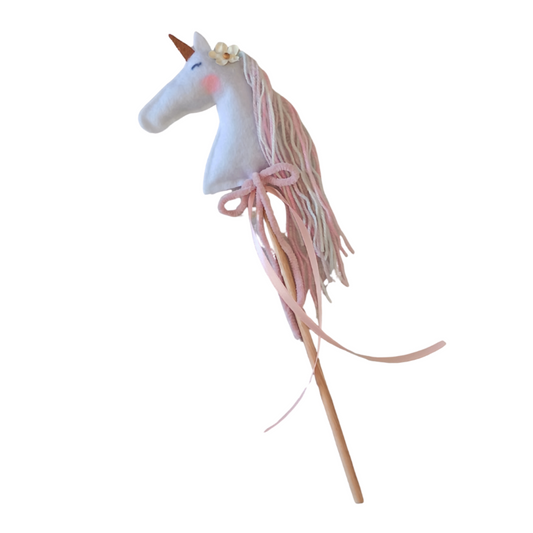 Unicorn toy with a wooden stick on a white background
