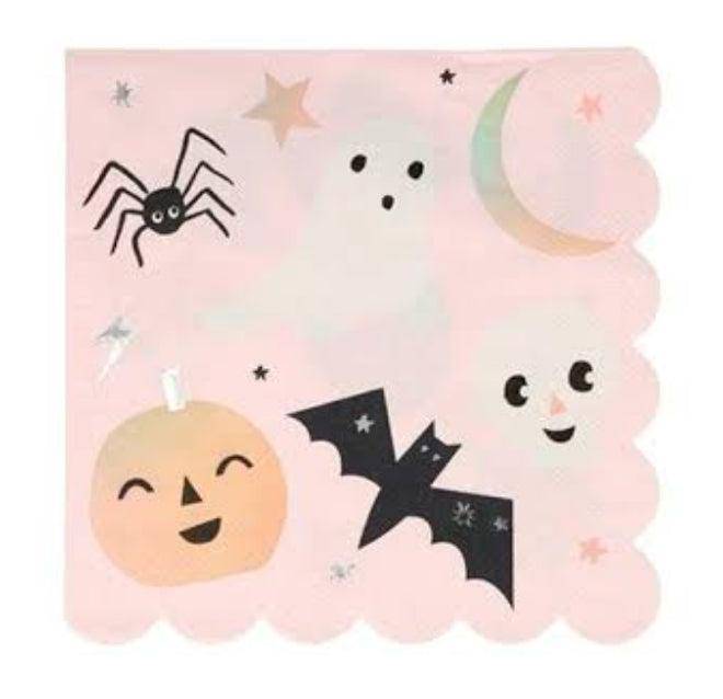 Halloween-themed napkins with ghost, spider, bat, and pumpkin designs on a pink background.